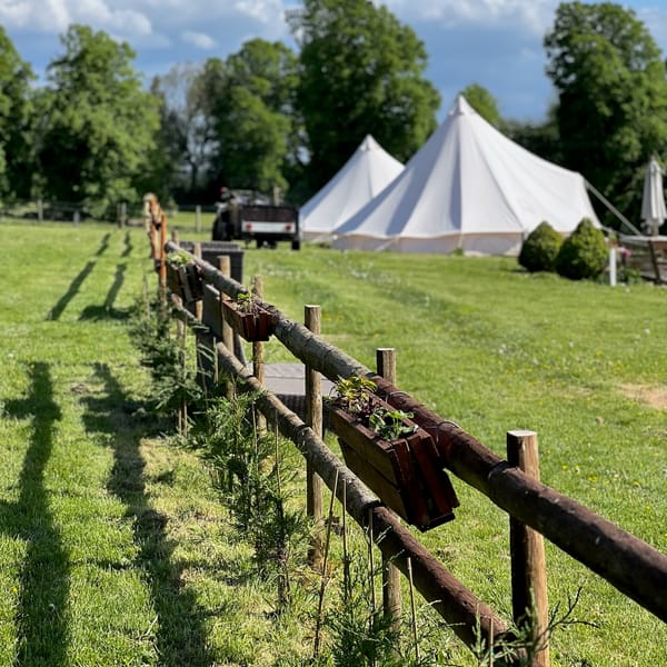 Bell tents along the fence line